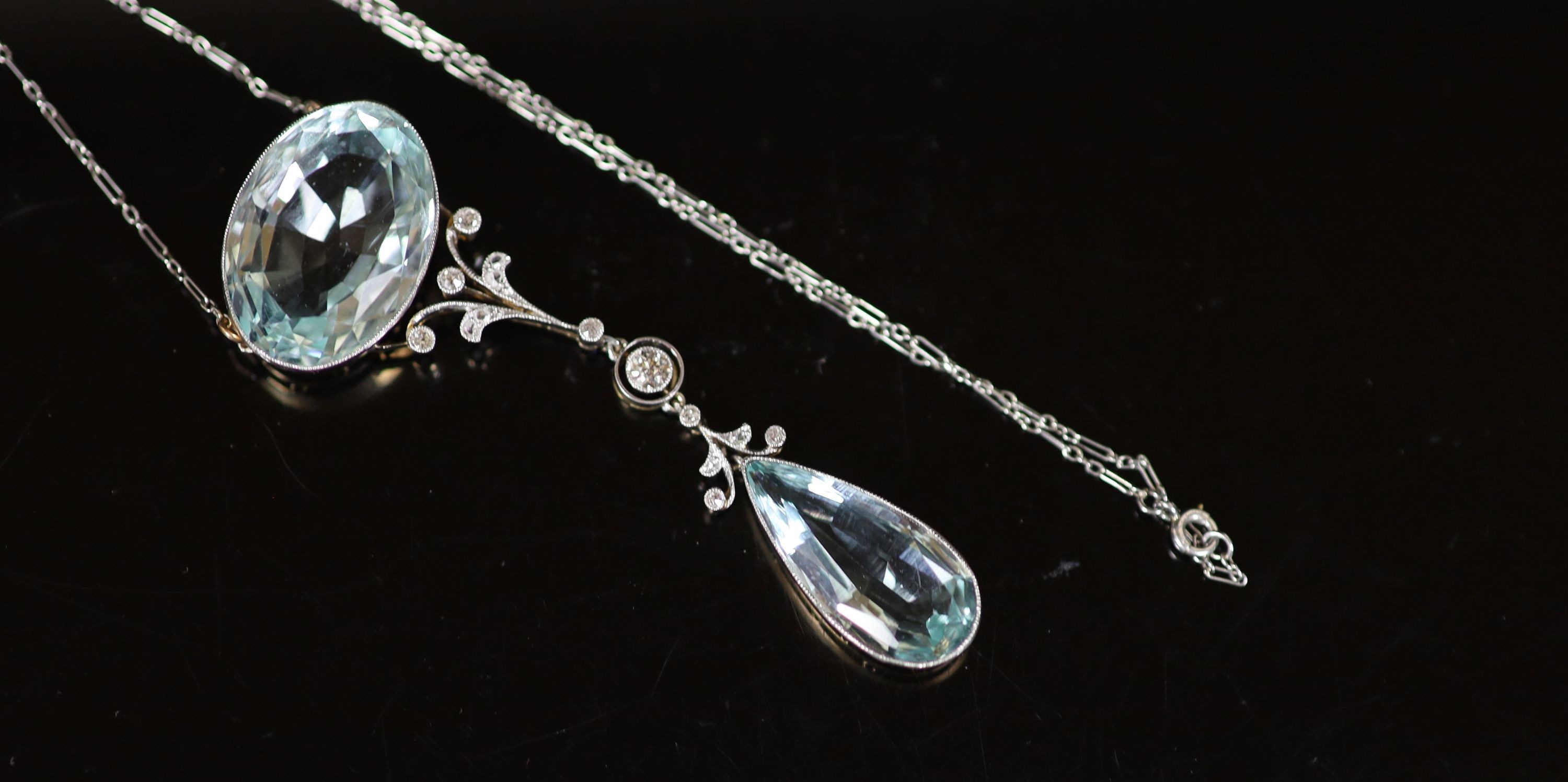 An early 20th century gold and platinum, millegrain set diamond and two stone aquamarine set drop pendant necklace, with a fine link platinum chain